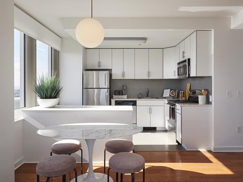 a kitchen and dining area with a table and chairs