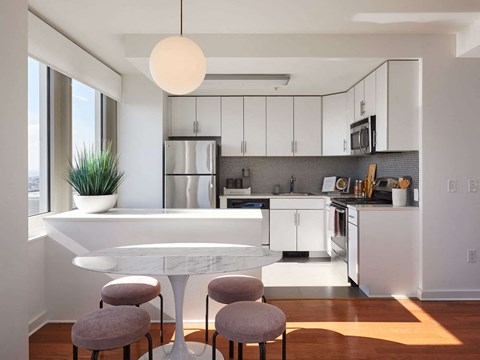 a kitchen and dining area with a table and chairs