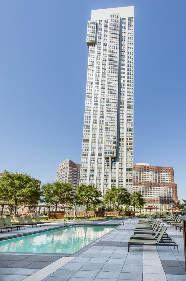 a swimming pool in front of a tall building