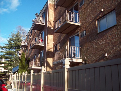 Building exterior with balconies and fencing