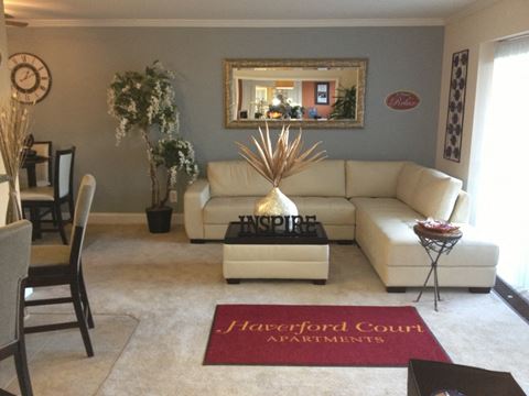 Furnished living room with beige carpeting and windowed doors to carpeting