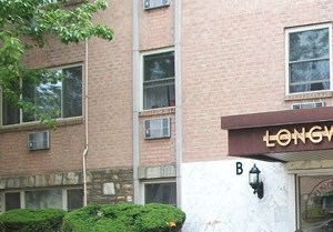 Exterior showing building entrance, benches, and gardens - Photo Gallery 4