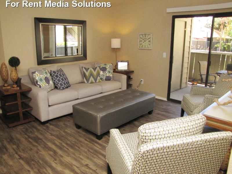 The Marina in Modesto living area with plank flooring and patio