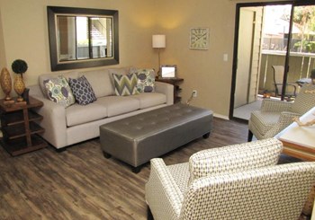 The Marina in Modesto living area with plank flooring and patio - Photo Gallery 8