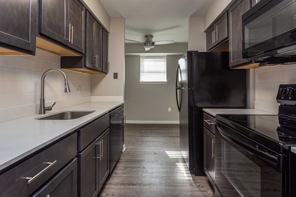 kitchen with quartz countertop and brown cabinets
