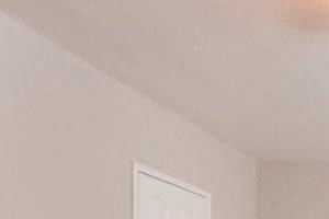 Bedroom Furnished bedroom with ceiling fan and air conditioner under two windows