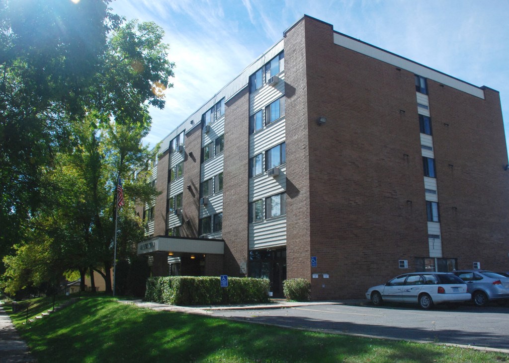 a large brick building with cars parked in front of it