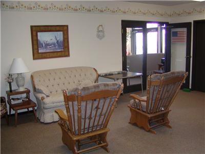 a living room with two rocking chairs and a couch