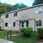a white house with a yard in front of it