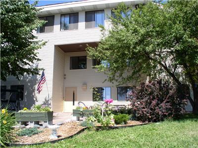 a white house with an flag in the yard