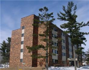 a brick building with trees in front of it