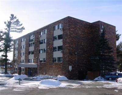a large brick building with snow in front of it