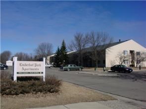 a white sign sitting in front of a building