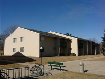 a building with a green bench in front of it