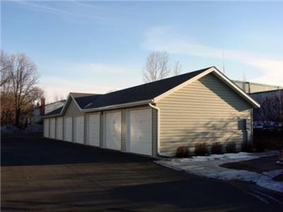 a building with a garage and a parking lot