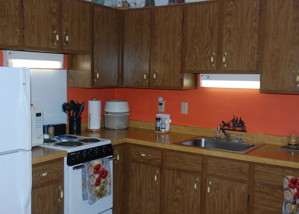a kitchen with a stove refrigerator and sink