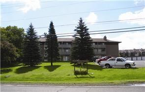 a car parked in front of an apartment building