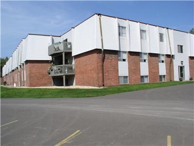 a large brick building with a street in front of it