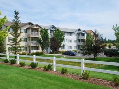 Community view from grass and fence Apartments in Spokane Valley, WA| Parkside Mirabeau Apartments