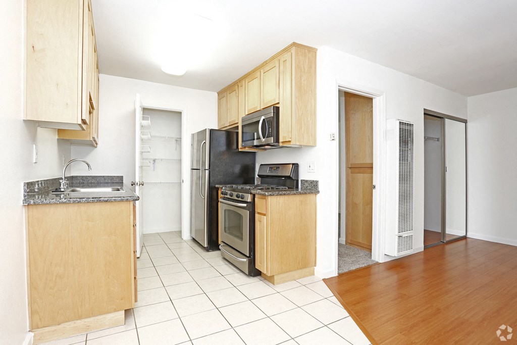 Kitchen with appliances at PARKSIDE BRENTWOOD, California