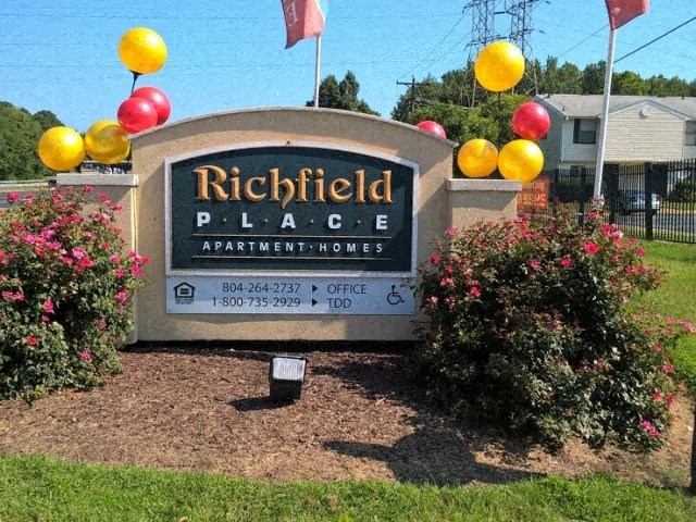 a sign with balloons on the sign