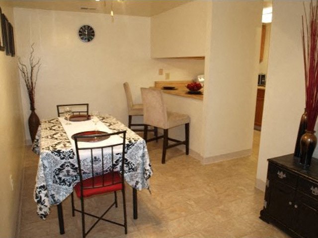 a dining room with a table and chairs