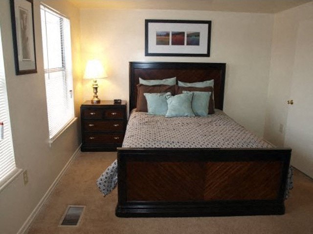 a bedroom with a bed and a window