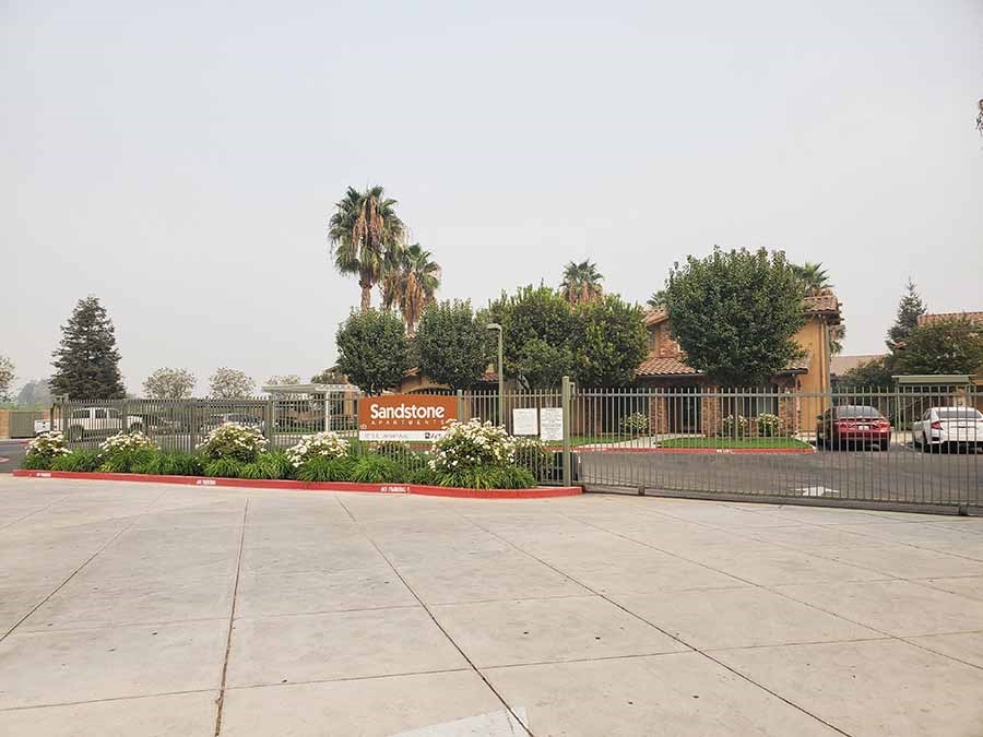 Entry sign to community l Sandstone Apartments in Fresno CA