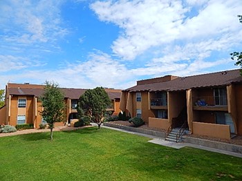 Sierra Meadows Apartments l Grass area large grass area and apt building Albuquerque NM Apartments For Rent l Sierra Meadows Apartments - Photo Gallery 2
