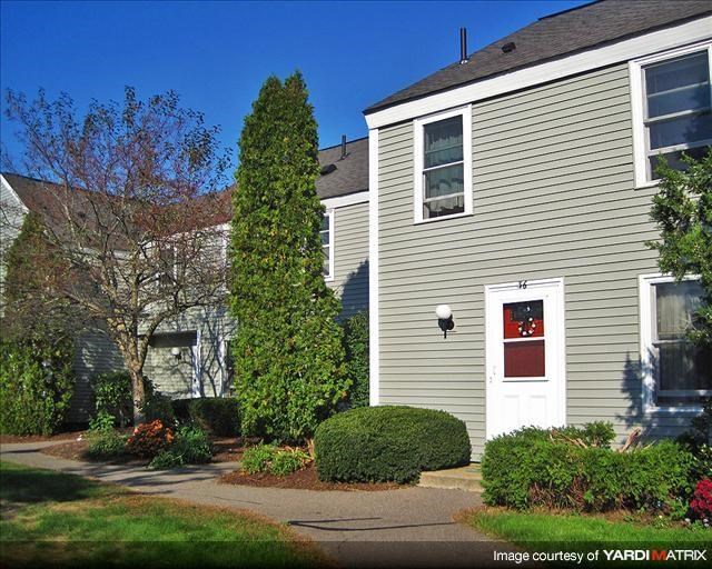 a house with a red door and a garden