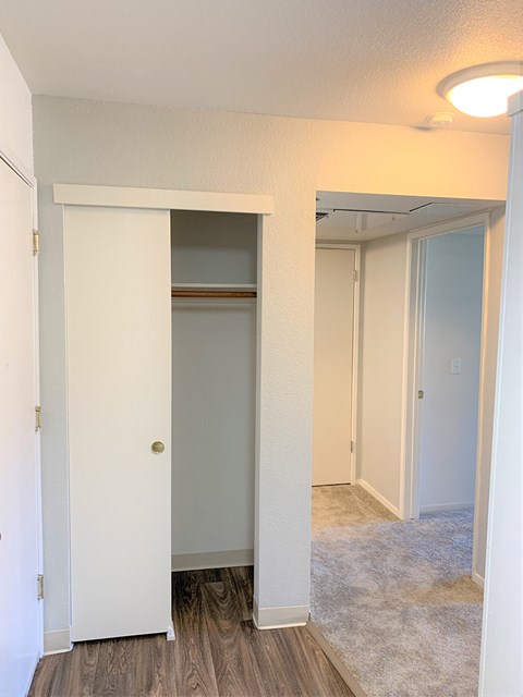 a bedroom with a closet and a mirrored door