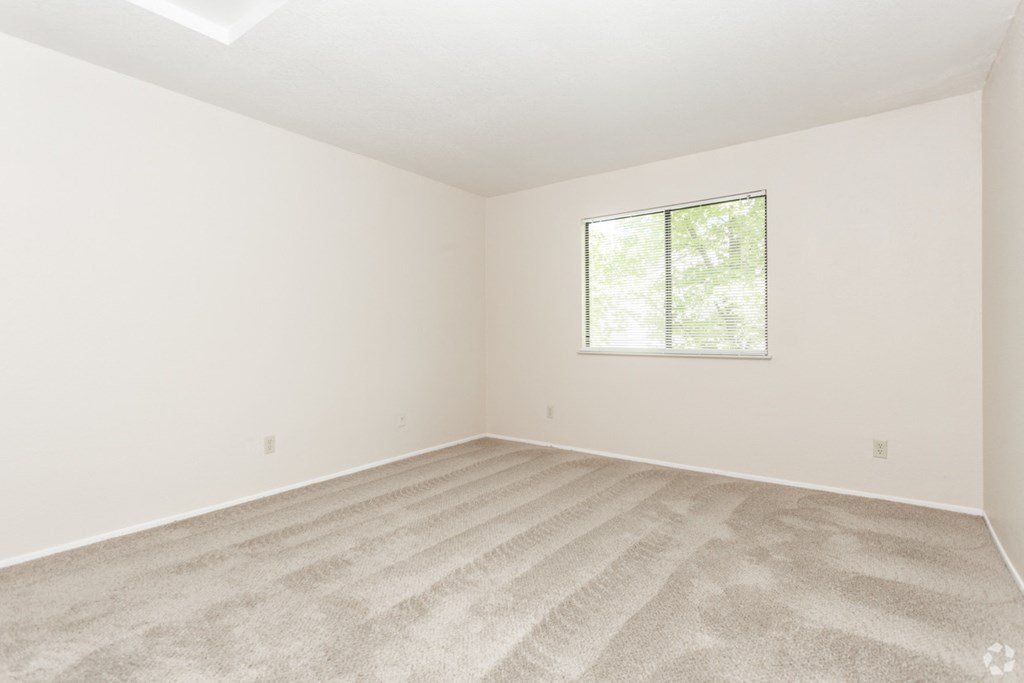 Bedroom with window  l Somersett Hills Apartments in Roseville Ca