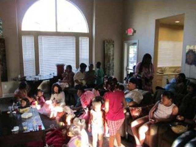 a group of people sitting and standing in a room