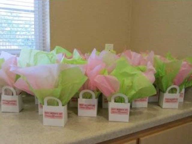 a group of pink and green bags on a counter