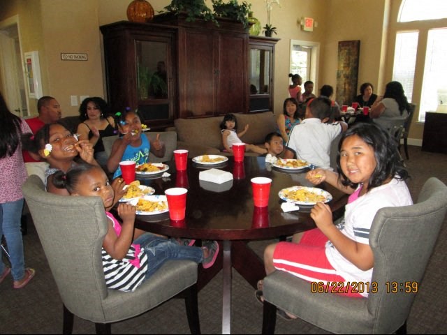 a group of people sitting around a table eating food