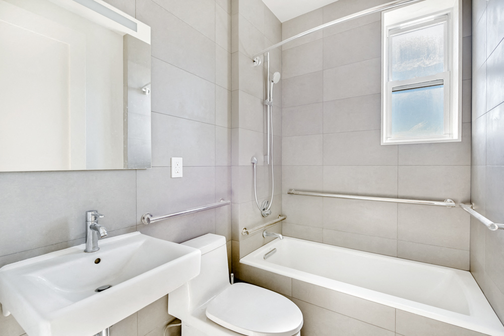 a bathroom with a sink toilet and a bath tub