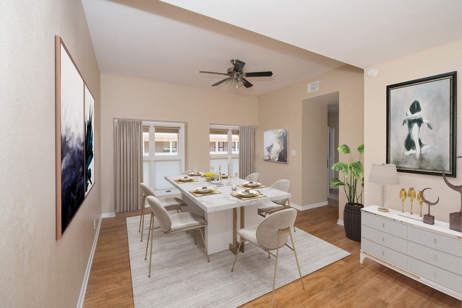 a dining room with a table and chairs and a ceiling fan