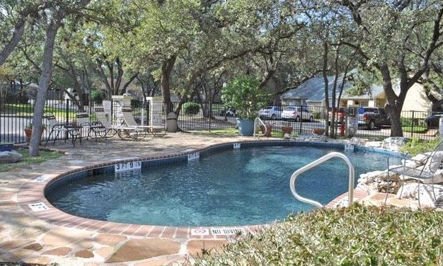 a swimming pool in a yard with trees