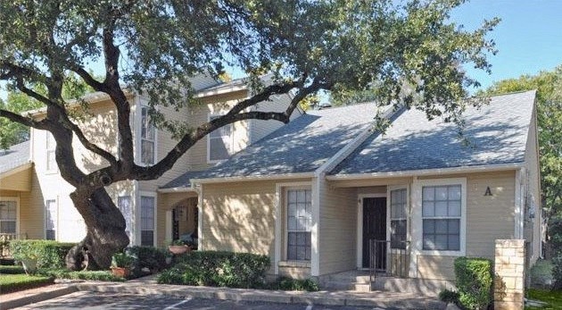 a house with a large tree in front of it
