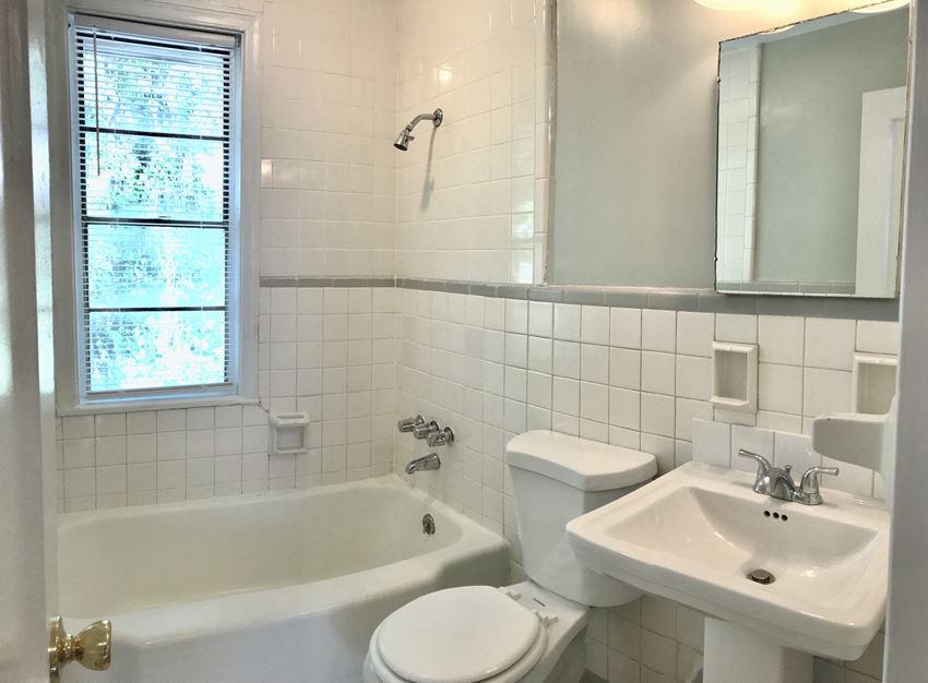 a white bathroom with a sink toilet and bath tub