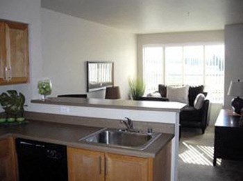kitchen and living room Tressa Apartments in Seattle, WA - Photo Gallery 17