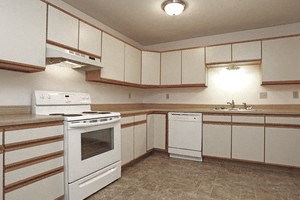Large kitchen with white cabinets and white appliances - Photo Gallery 5