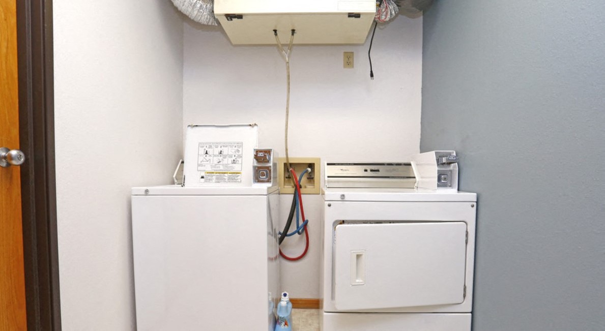 a kitchen with a refrigerator freezer and a washing machine
