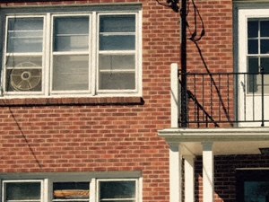 a brick house with a porch and a bike parked in front of it