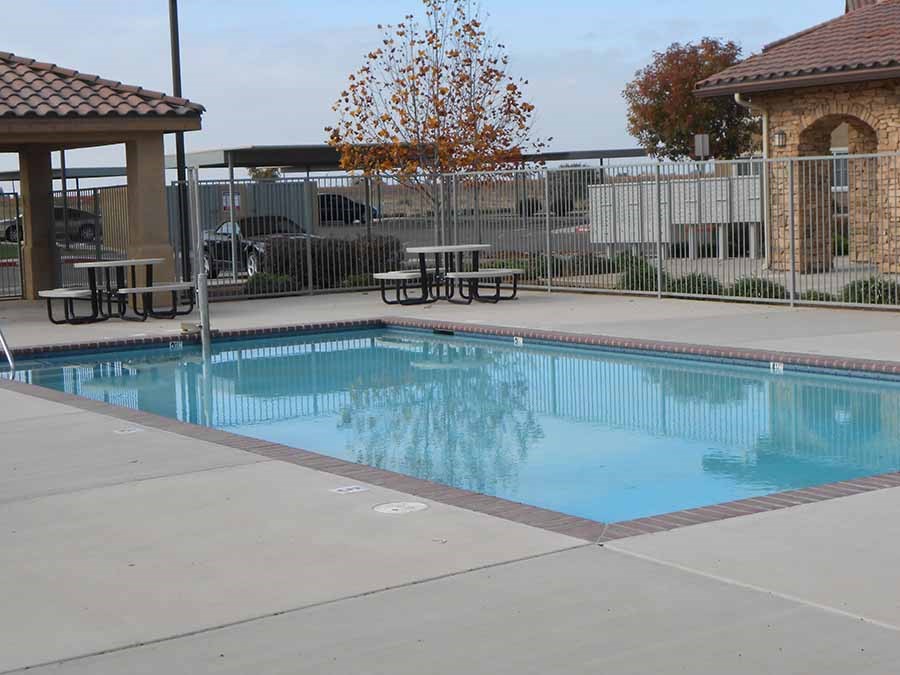 Pool with seating l Villa Escondido Apartments in Orange Cove CA