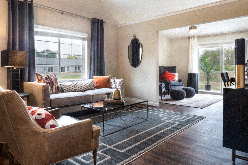 A living room with a couch, chair, and coffee table.