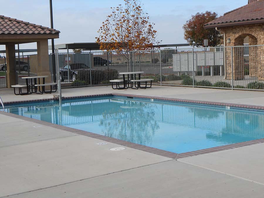 Pool with seating l Villa Esperanza Apartments in Avenal CA
