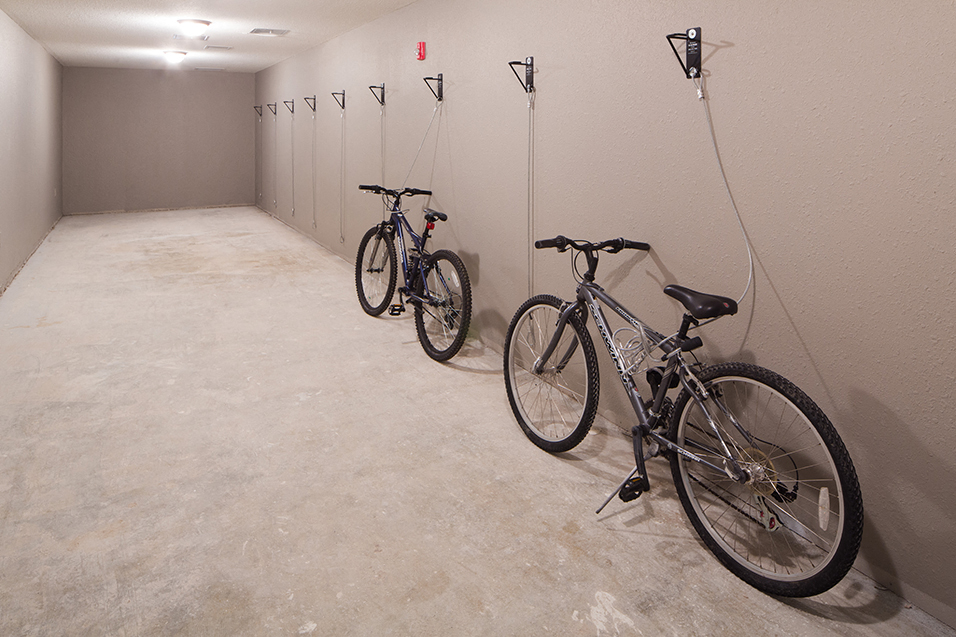 bike storage room with two bikes chained to the wall security system