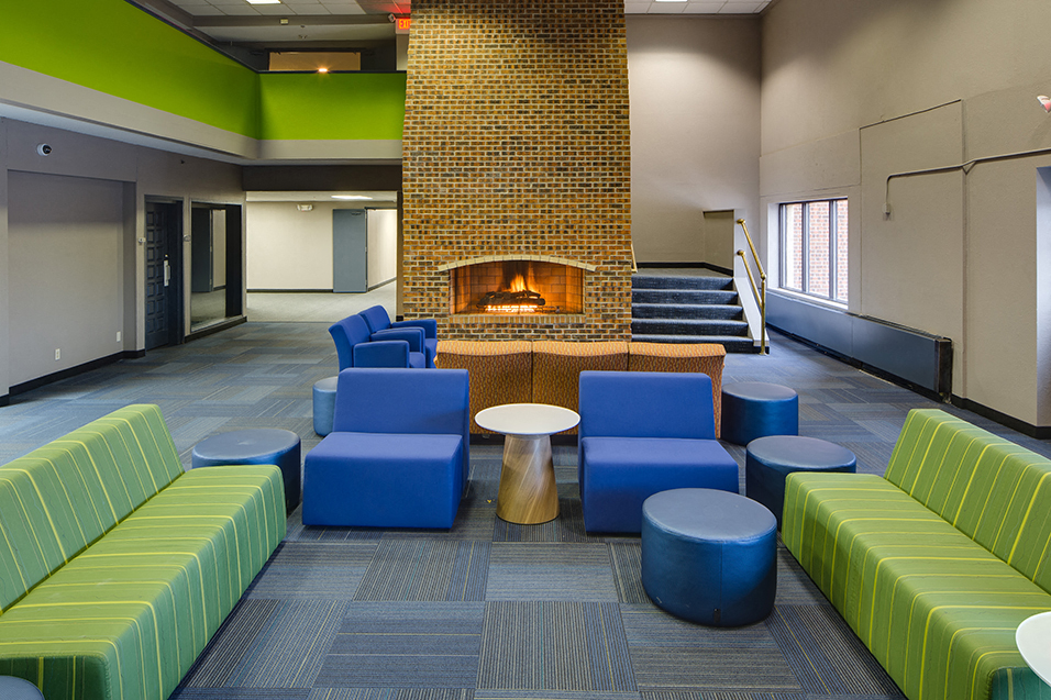 lobby with multicolored lounge chairs and a fireplace