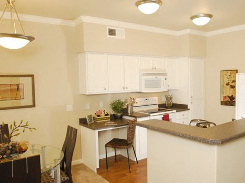 a kitchen with a bar and a dining table